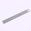 A stainless steel measuring ruler showing markings from 1 to 15 centimeters.