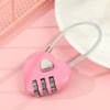 A pink heart-shaped combination padlock with a silver key ring and chain, resting on a light pink surface.