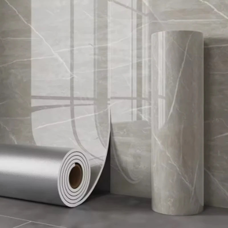 Roll of marble imitation self-adhesive wall stickers against a light gray textured wall.