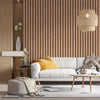 Interior view of a modern living space featuring light wood grain wall panels, a white sofa, and woven pendant lighting.