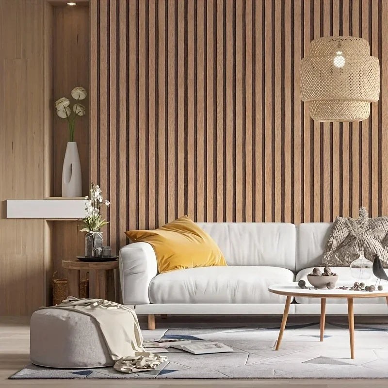 Interior view of a modern living space featuring light wood grain wall panels, a white sofa, and woven pendant lighting.