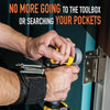 A hand is using a magnetic wristband tool to hold and drive a screw into a wooden surface.