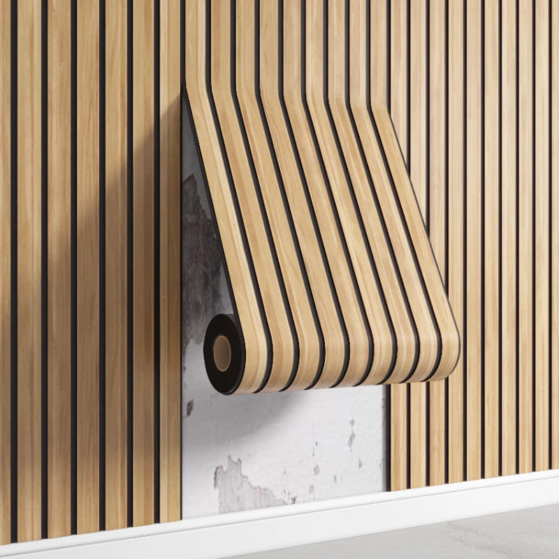 A roll of wood-grain wall decal sticker is mounted on a light gray wall with vertical wooden slats.