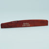A wooden guitar bone bridge saddle with the inscription GUYKOV ATR-7239