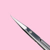 A close-up view of a professional stainless steel nail cuticle trimmer with a sharp metal tip.