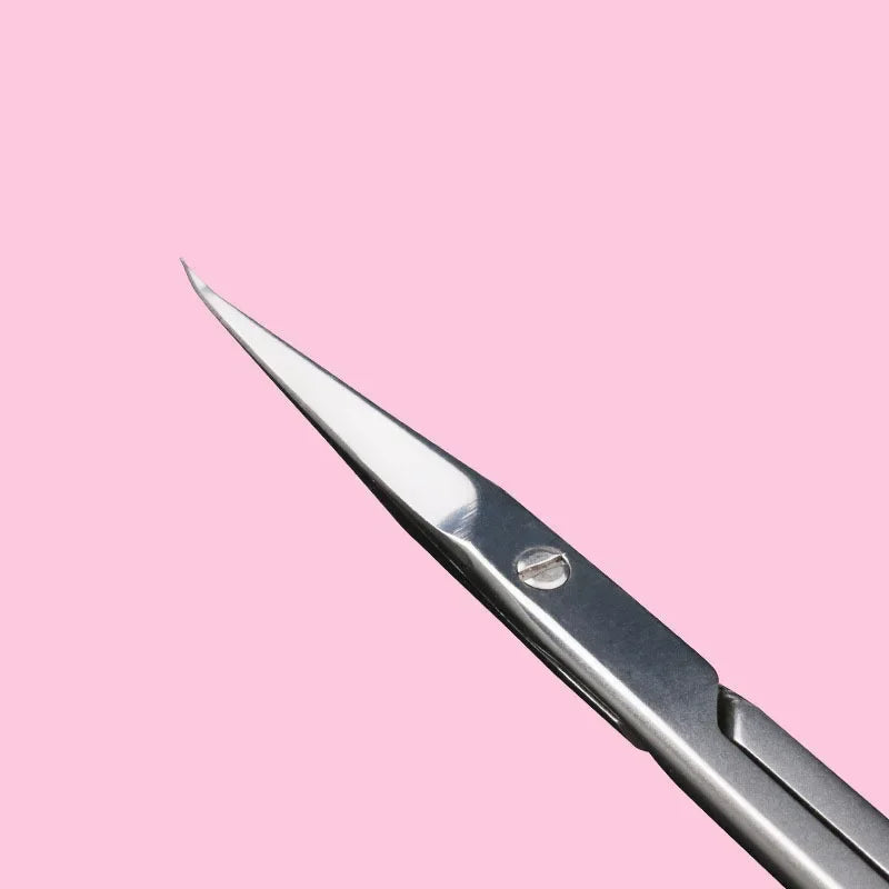 A close-up view of a professional stainless steel nail cuticle trimmer with a sharp metal tip.
