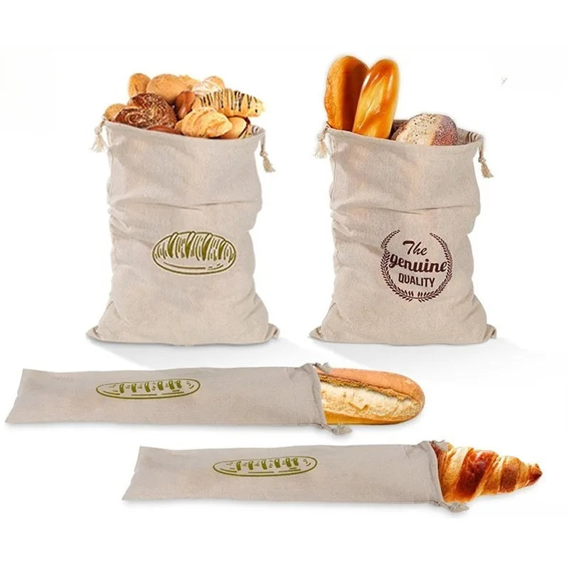 Reusable linen drawstring bag filled with assorted bread loaves and rolls.