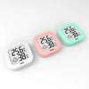 Two digital thermometers, one pink and one mint green, displaying a temperature of 35.6 degrees Celsius.