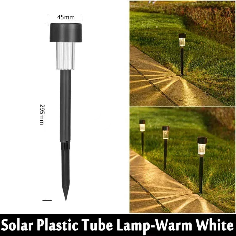 A black solar plastic tube lamp mounted on a stake, illuminating an outdoor pathway.