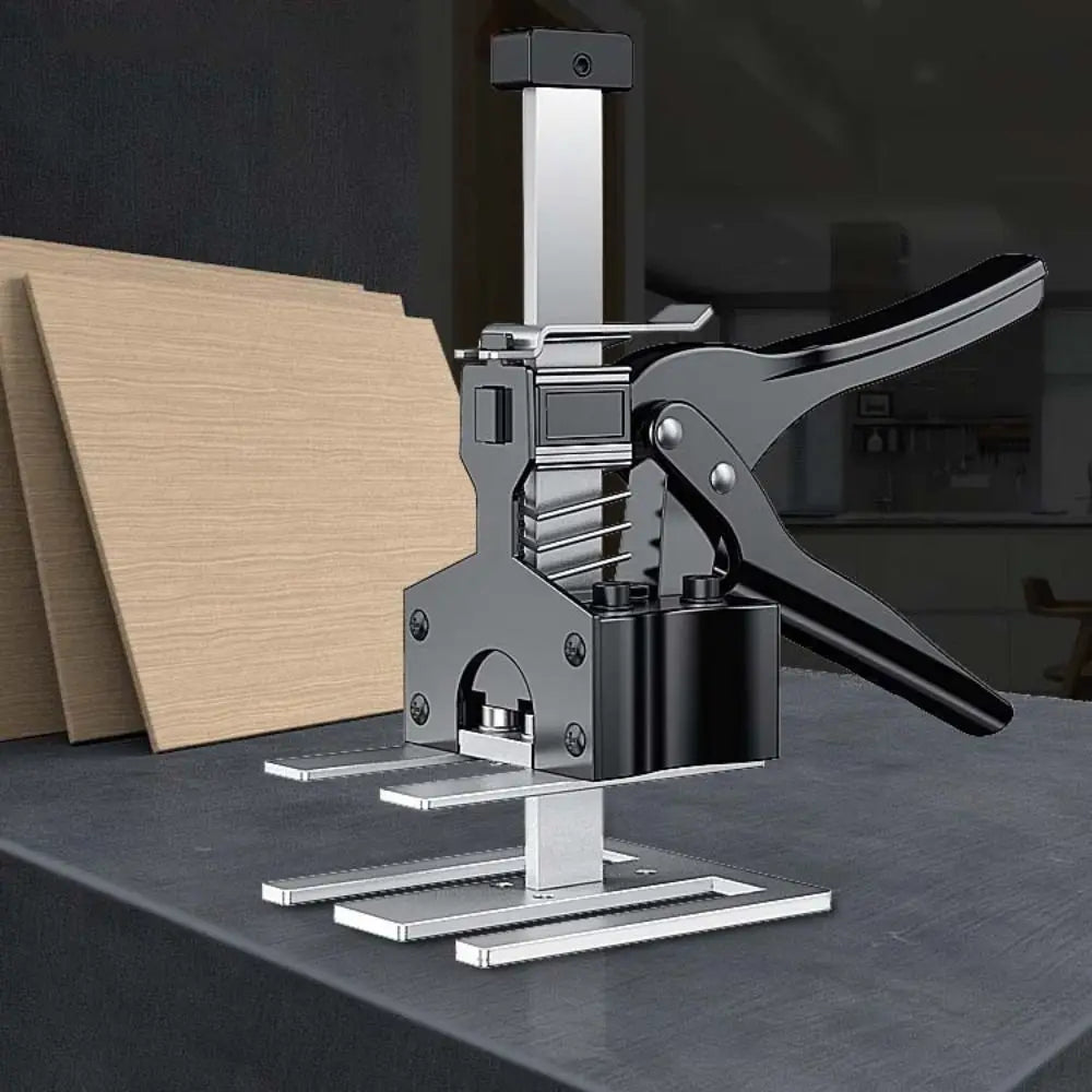 A silver precision furniture lifter and arm tile adjuster tool resting on a dark surface.