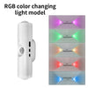 A white wall light fixture demonstrating RGB color changing light model with various colored beams.