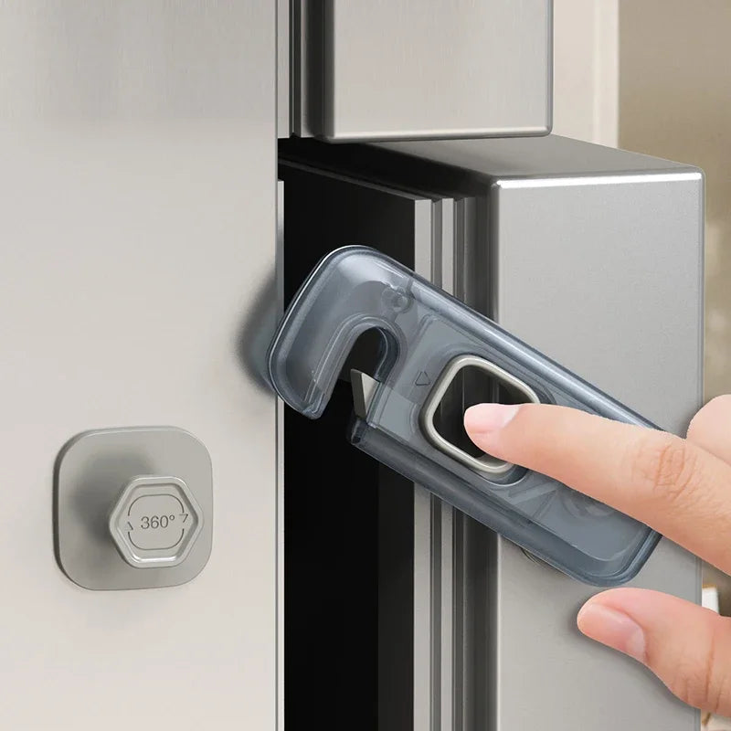 A hand is operating a clear plastic safety lock on a cabinet door, demonstrating the toddler cabinet safety lock set.