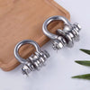 A heavy-duty stainless steel buckle pulley is shown resting on a wooden surface.