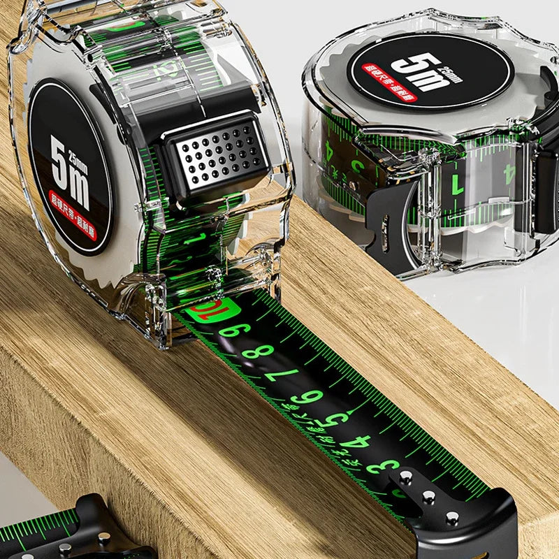 A close-up view of a clear plastic metric tape measure with a black digital block and green markings on a wooden surface.