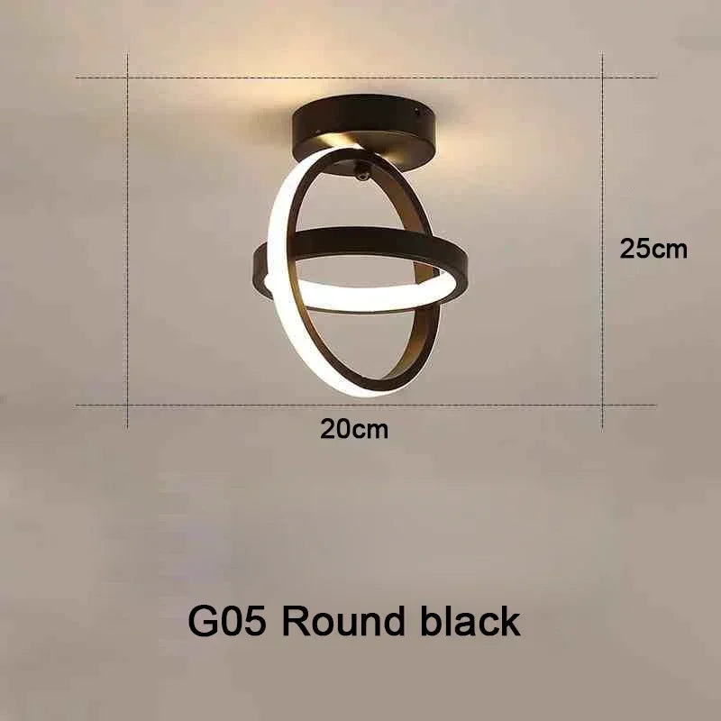 Lámpara de techo LED negra redonda con diseño circular montada en una pared blanca.