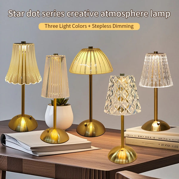 A collection of three Star dot series lamps with different light colors and dimming features displayed on a wooden table.