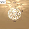 White crystal chandelier lamp with a round shade and decorative cutouts, shown hanging from the ceiling.