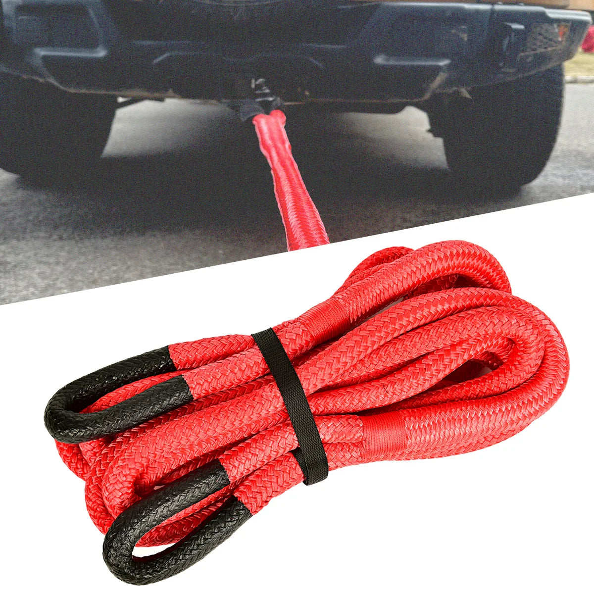 A coiled red and black heavy-duty nylon recovery tow rope is shown next to a vehicle component.