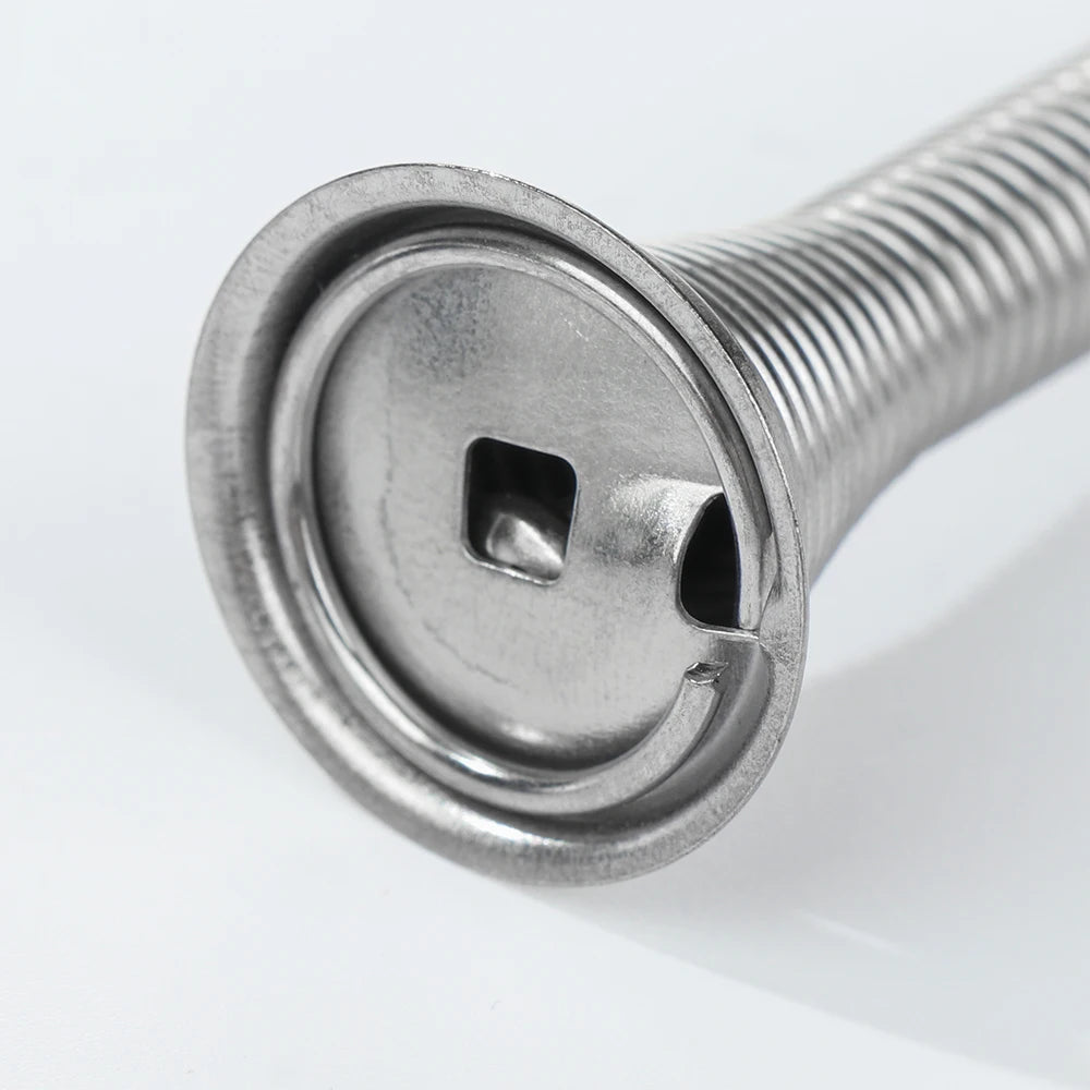 A close-up view of a silver decorative iron spring door stopper with a square opening.
