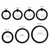 A collection of black silicone rings with various diameters and shapes for erection enhancement.