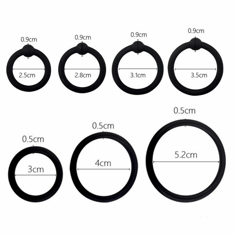 A collection of black silicone rings with various diameters and shapes for erection enhancement.