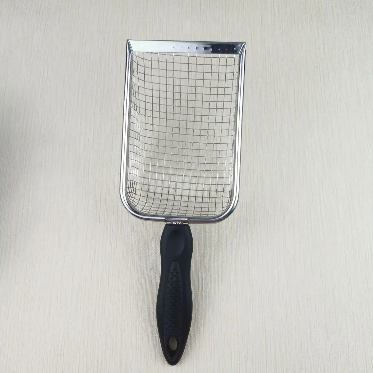 A stainless steel cat litter scoop with a mesh basket and a black handle.