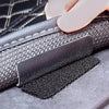 Close-up of heavy duty hook and loop strips being applied to a leather surface.