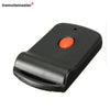 A black garage door remote transmitter with an orange button.
