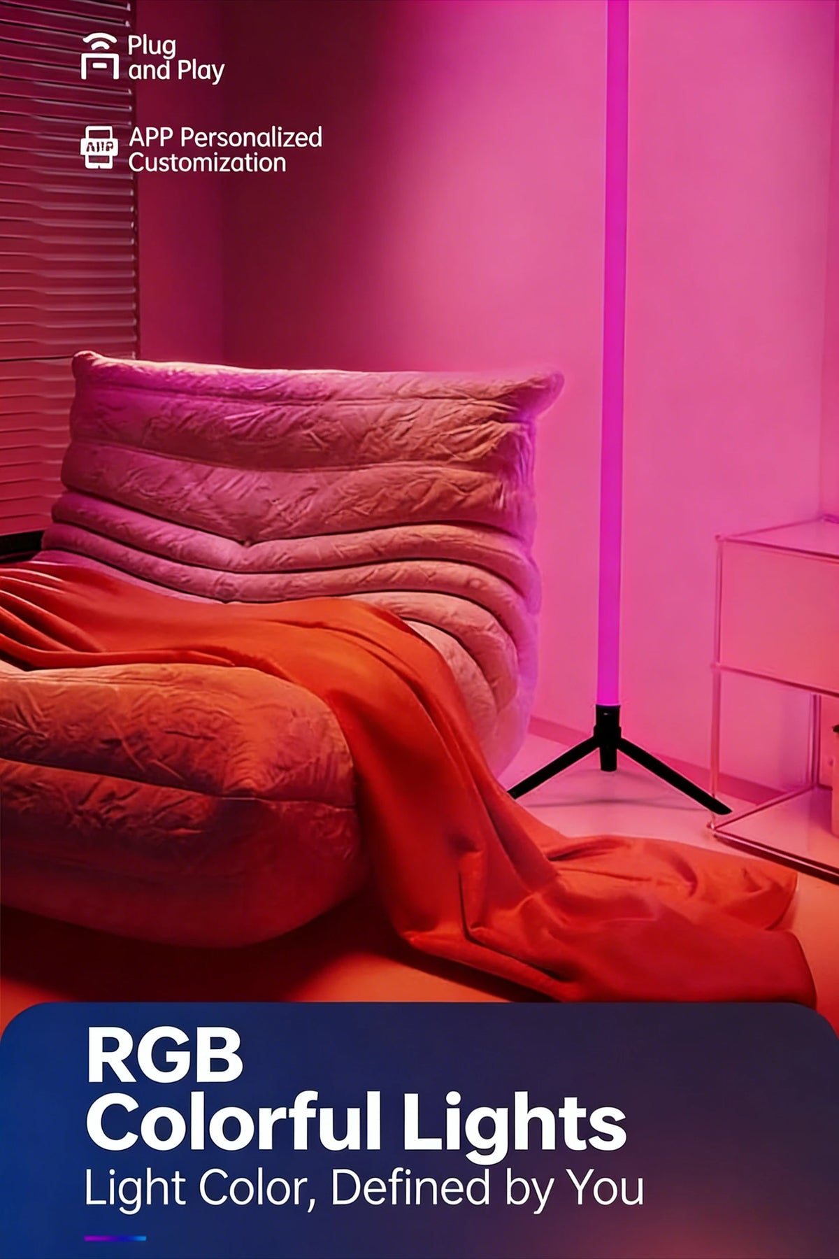 A pink room features an orange fabric draped over a sofa, illuminated by a vertical purple RGB floor lamp.