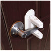 A white universal adhesive door latch with a silver finish is mounted on a dark brown wooden door.