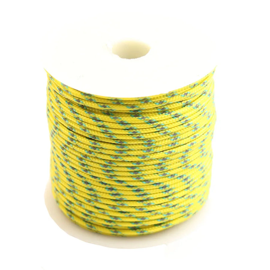 Spool of yellow reflective paracord rope coiled on a white background.