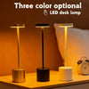 Three color optional LED desk lamps shown in gold, black, and white on a wooden surface.