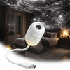 A white projector night light with a flexible cord is shown illuminating a bedroom setting under a starry sky backdrop.