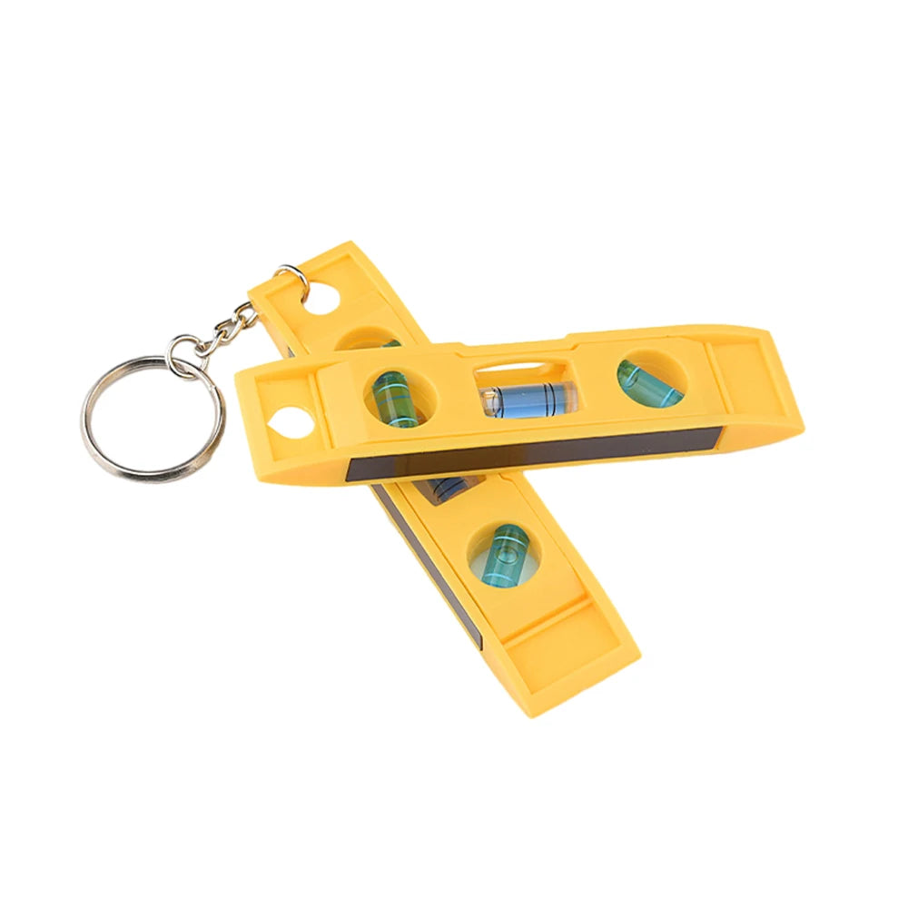 Yellow mini bubble level with a keychain, featuring multiple measurement bubbles.