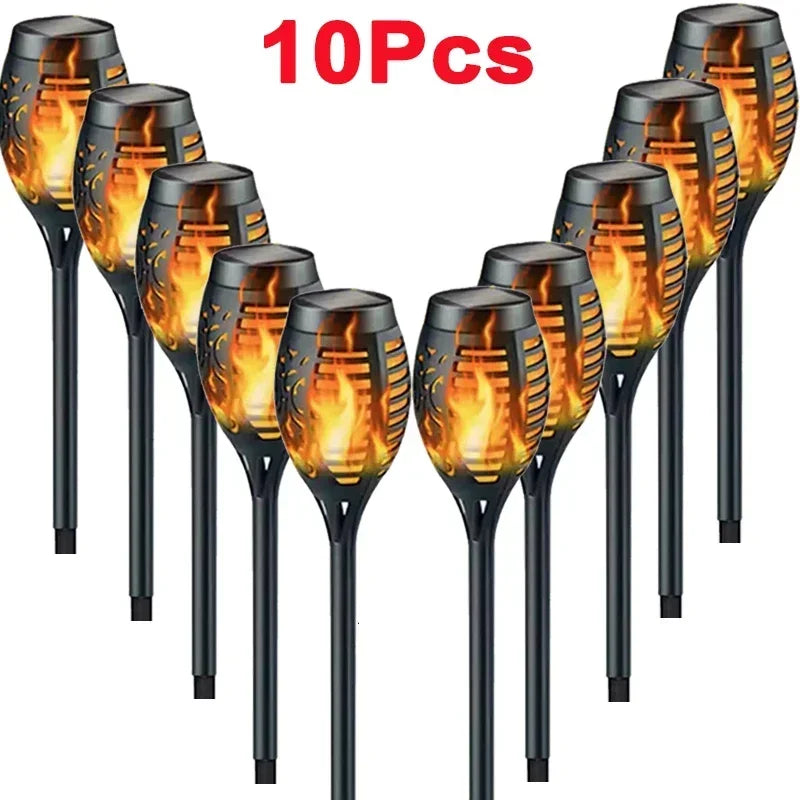 Ten black solar flame torch lights for outdoor decoration displayed in a row.