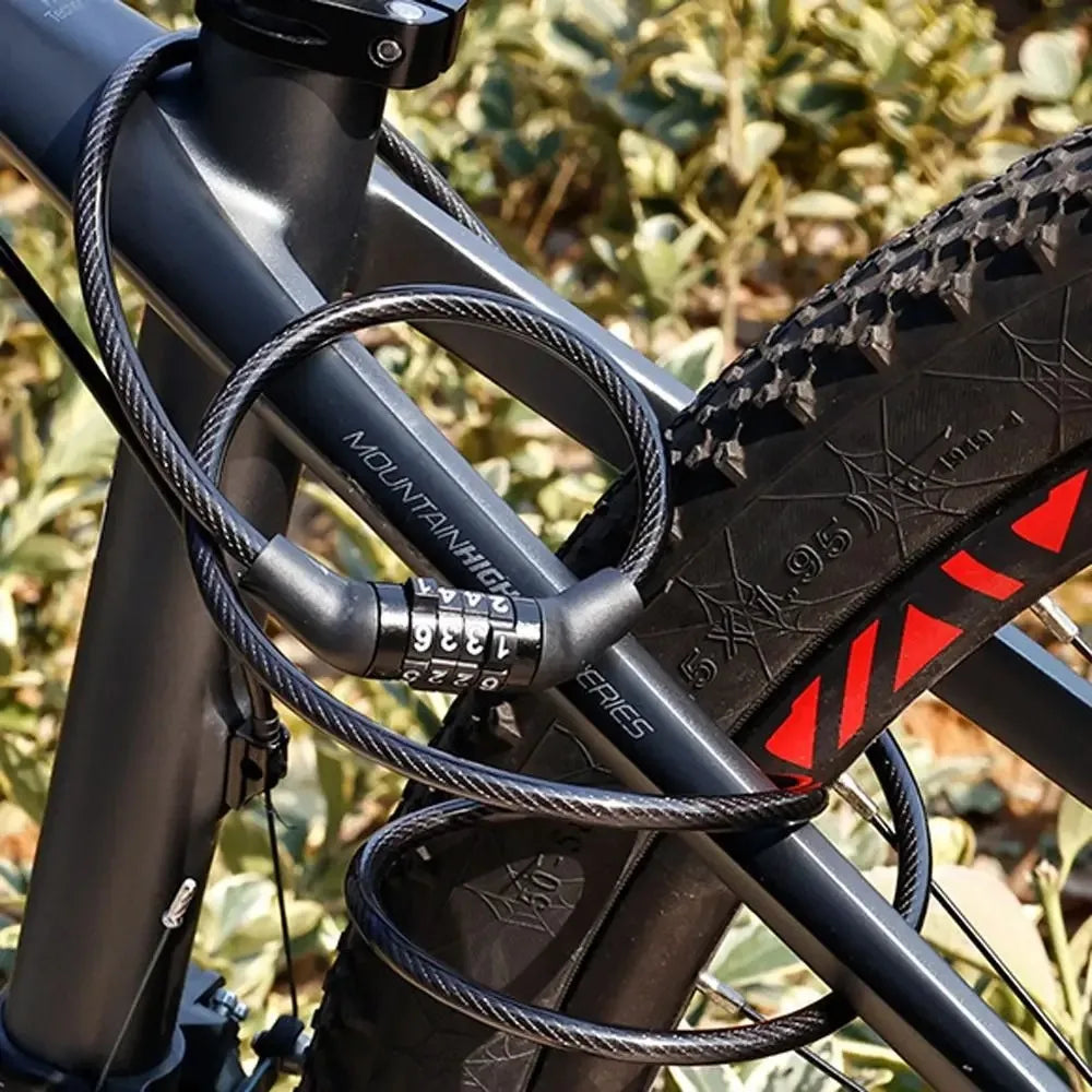 A close-up of a black portable anti-theft bike cable lock coiled around a bicycle frame.