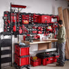 A red magnetic bin for tool organization is mounted on a wall rack in a workshop setting.