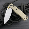 A light tan folding pocket knife with a silver blade is shown attached to a black cord.