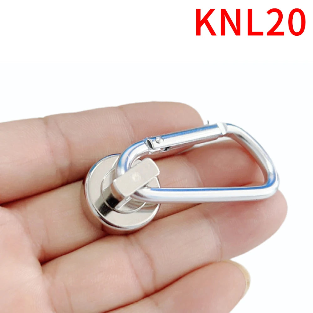 A hand holds a silver heavy duty magnetic hook with a swivel carabiner attached.