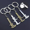 A set of precision metal jewelry measuring rulers and calipers attached to a keychain.