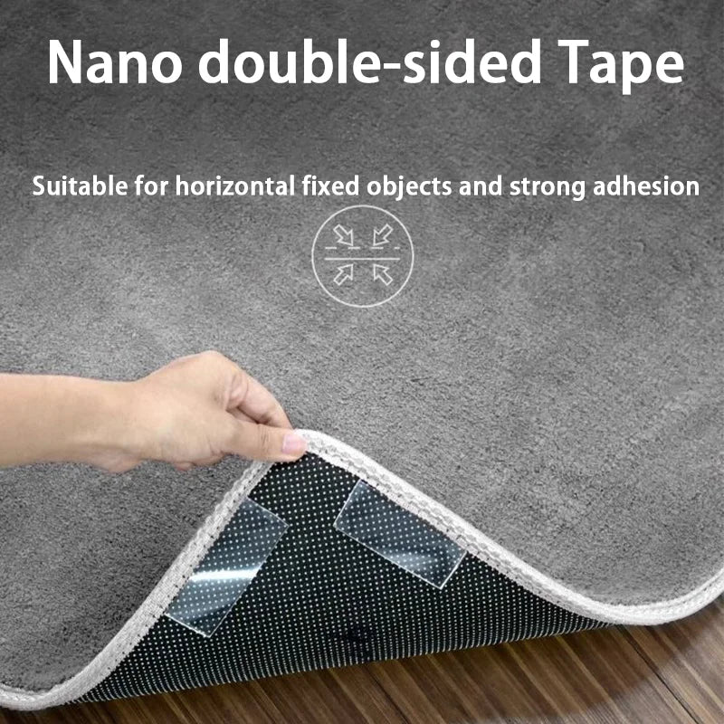 A hand applies nano double-sided tape to a gray fabric surface for strong adhesion.
