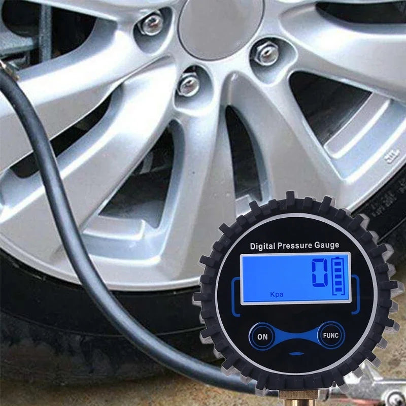 A digital tire air pressure gauge is connected to a car wheel, measuring pressure in kPa.