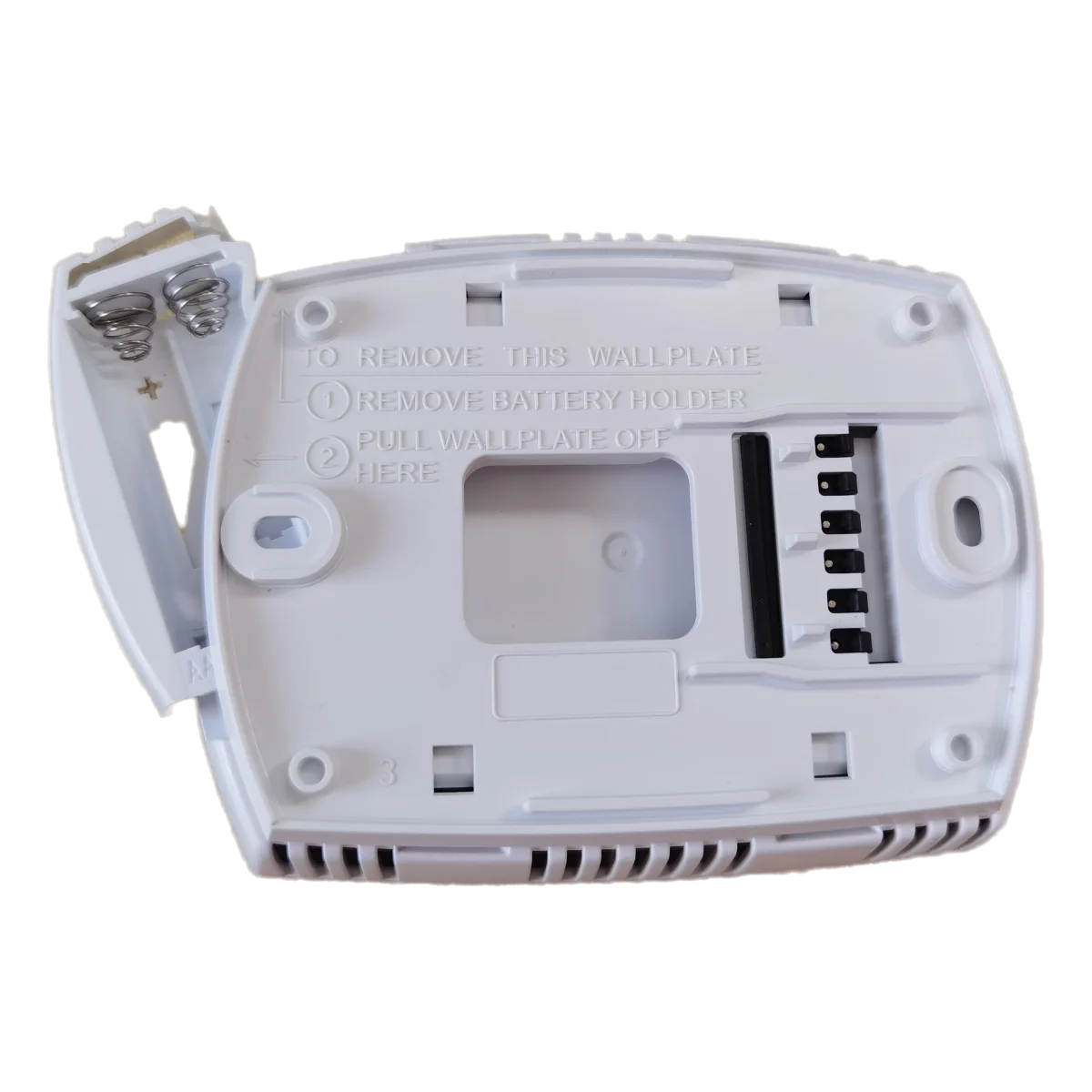 A white digital thermostat for heat pump systems showing instructions to remove the wallplate and battery holder.
