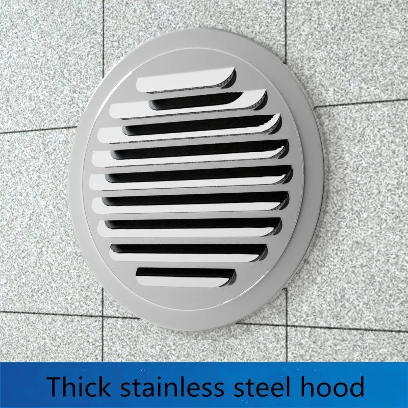 A round, silver stainless steel air vent grille installed in a tiled wall.