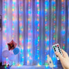 A vertical curtain of multi-mode fairy lights illuminates a purple background, with a hand holding a remote control in the fo