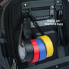 Adjustable electrical tape holder with colored tape rolls hanging on a black tool bag