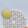 A hand holds an integrated stone trimming polishing disc set with a perforated, geometric pattern.