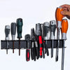 A heavy duty wall mounted tool storage rack displaying various hand tools like pliers and screwdrivers.