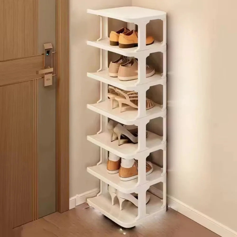 A white stackable vertical shoe rack organizer with multiple tiers holding various pairs of shoes.