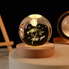 A glass crystal ball night light with a glowing filament, featuring a silhouette of a growing plant and the text I love you.
